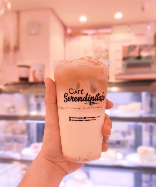 Cafe Serendipitale Hand Holding Cup of Iced Coffee