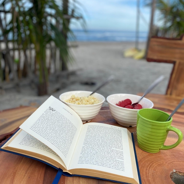 Promised Land Beach Resort lounging with book and coffee and food